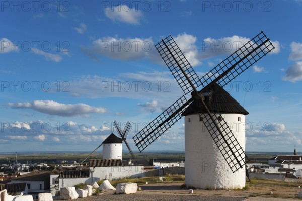 Windmill in a village with white houses and wide views under a clear sky, windmills, Campo de