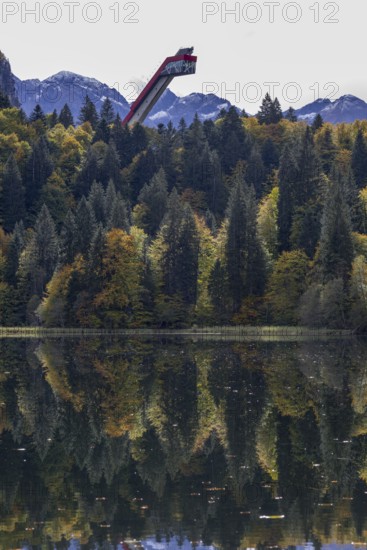 Freibergsee lake in autumn, behind it the Heni-Klopfer ski jump, Allgäu Alps, Allgäu, Bavaria,