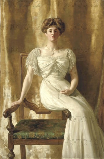 A woman in an ivory-coloured dress sits on an ornate chair against a golden background. portrait of