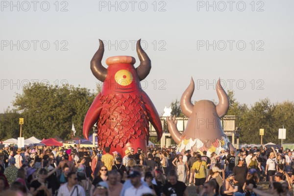 Festival visitors in front of the Highfield mascot Highviech at the Highfield Festival on Friday,