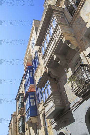 Balconies of houses historic street in city centre of Valletta, Malta, Europe