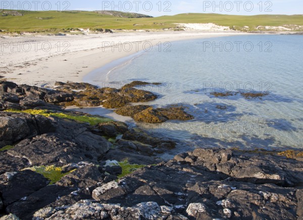 Rocky headland and sandy beach at Bagh a Deas, South Bay, Vatersay island, Barra, Outer Hebrides,