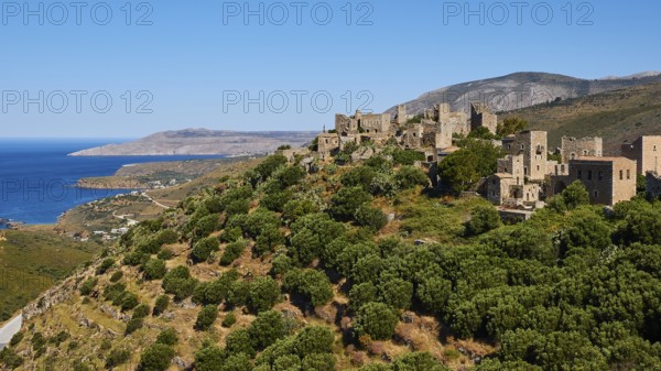 Medieval village overlooking the sea from a wooded hillside, Vathia, residential tower village,
