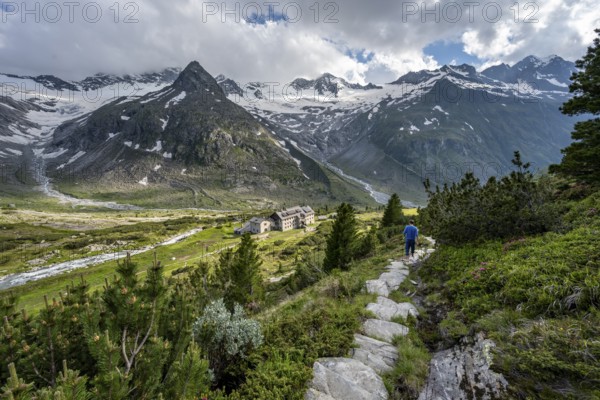 Mountaineer barefoot on a hiking trail, mountain hut Berliner Hütte, mountain peak Steinmandl,