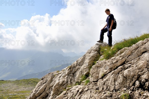 Ten-year-old boy hiking, Nebelhorn, Allgäu Alps, Bavaria, Germany, Europe