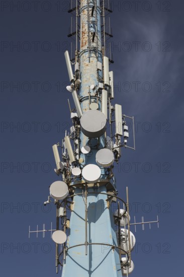 Mobile phone communications tower with antennas against blue sky, Mount Srd, Dubrovnik, Croatia,
