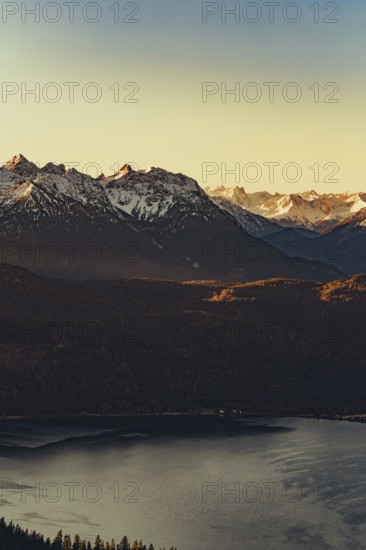 Trail running in autumn on the Jochberg on Lake Walchensee against the wonderful backdrop of the