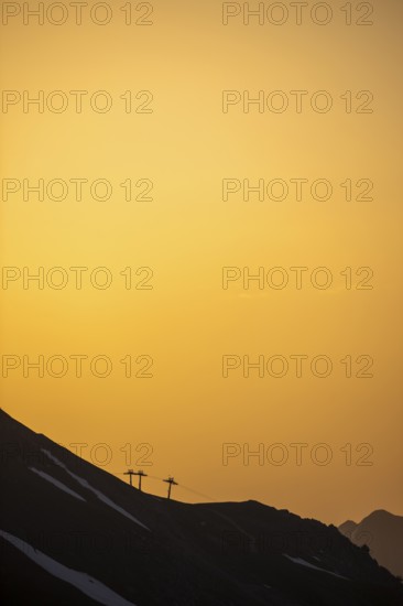 Summit with ski lift masts in the morning light, Lech, Lechquellengebirge, Vorarlberg, Austria,
