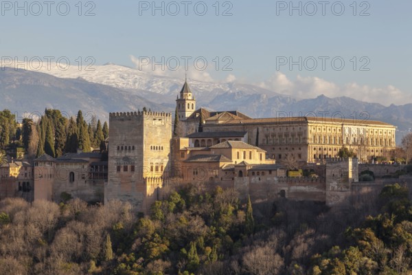 Alhambra on the Sabikah hill, Moorish city castle, Nasrid palaces, behind the snow-covered Sierra