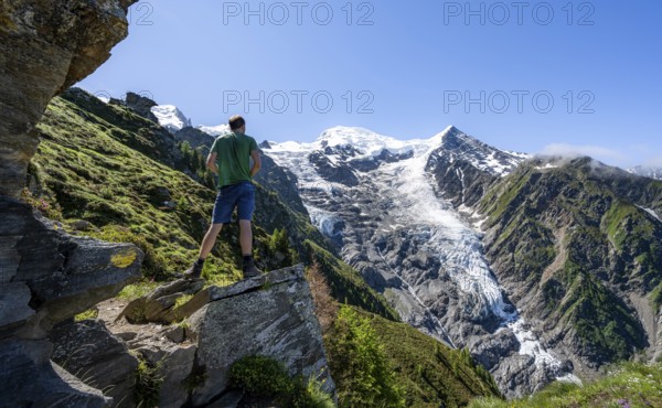 Mountaineer in front of mountain landscape, view of glacier Glacier de Taconnaz, hike La Jonction,
