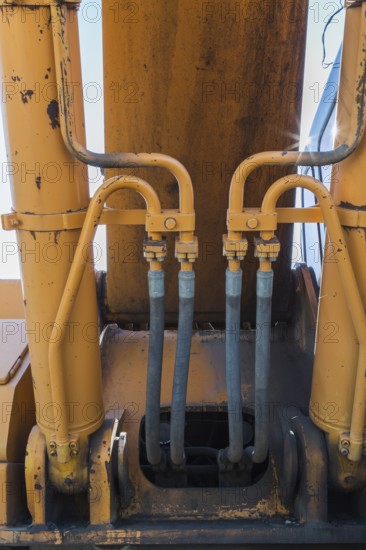 Electrical power and hydraulic fluid supply lines on heavy duty backhoe excavator, Quebec, Canada,