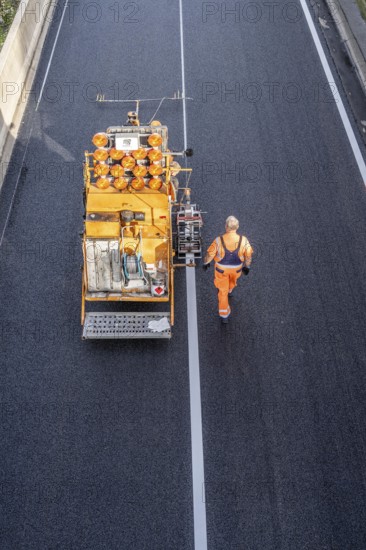 Marking work after the application of new whisper asphalt surface for the A40 motorway, in the