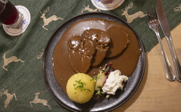 Roast beef with gingerbread sauce and dumplings, served in a Franconian inn, Bavaria, Germany,