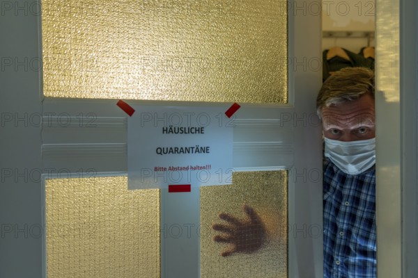 Symbolic image Domestic quarantine, man is in isolation at home due to a suspected corona