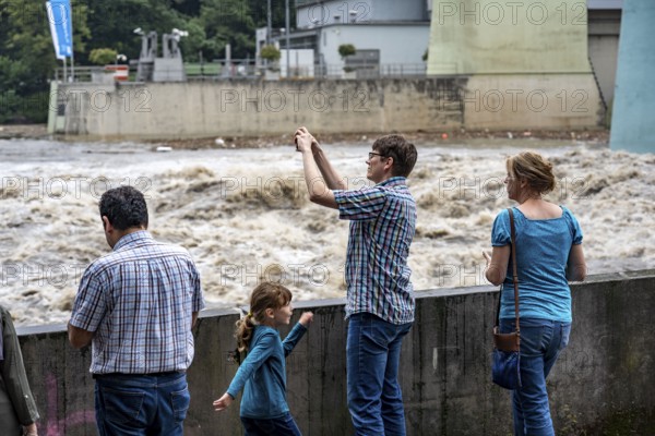 Weir of the Lake Baldeney in Essen, the masses of water roar through the open weirs, spectators,