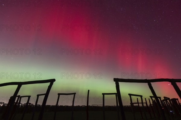 Northern lights (aurora borealis) over the ring sanctuary of Pömmelte, prehistoric circular ditch