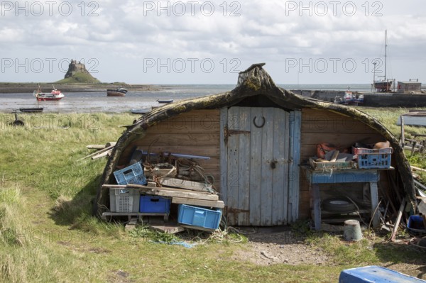 Upturned boats used as storage shed, Holy Island, Lindisfarne, Northumberland, England, UK