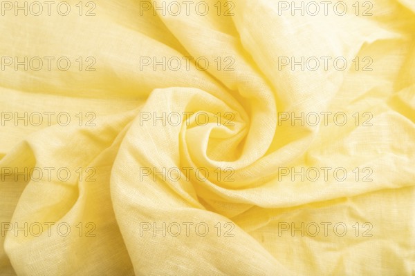 Fragment of yellow linen tissue. Top view, flat lay, natural textile background and texture. wave