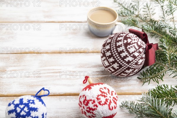 Christmas or New Year composition. Decorations, knitted balls, fir and spruce branches, cup of