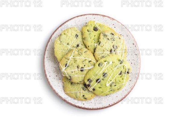 Green cookies with chocolate and mint on ceramic plate isolated on white background. top view, flat