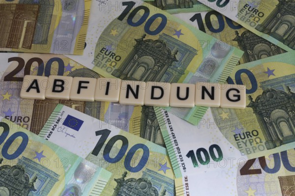 Symbolic image of severance pay: Letters on euro notes show the word severance pay