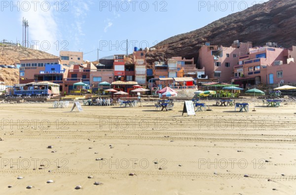 Sandy beach and buildings, Legzira, southern Morocco, north Africa