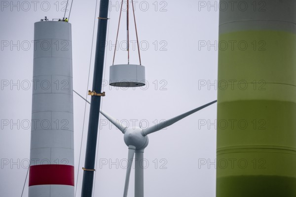 Construction of the tower of a wind power plant in a wind farm near Issum, 9 older wind turbines