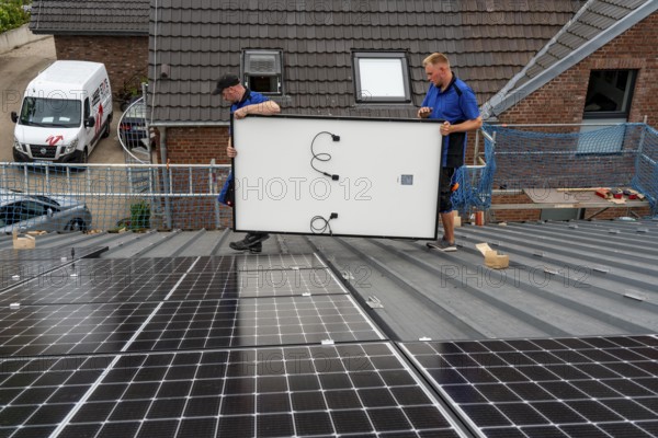 Installation of solar modules on the roof of a barn on a farm, over 240 photovoltaic modules are