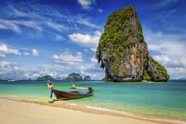 Thailand tropical vacation concept background, Long tail boat on tropical beach with limestone