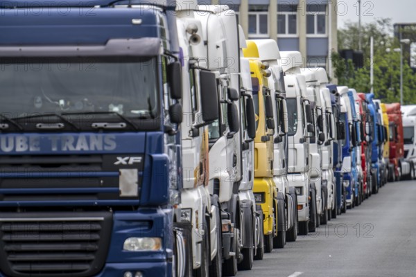 Truck tractors, exclusively from Eastern European countries, park in the harbour area, the canal