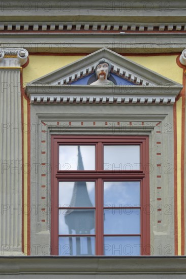 Window with decorations and grimace, face, head, grimace, envious head, detail, pilasters, fluting,