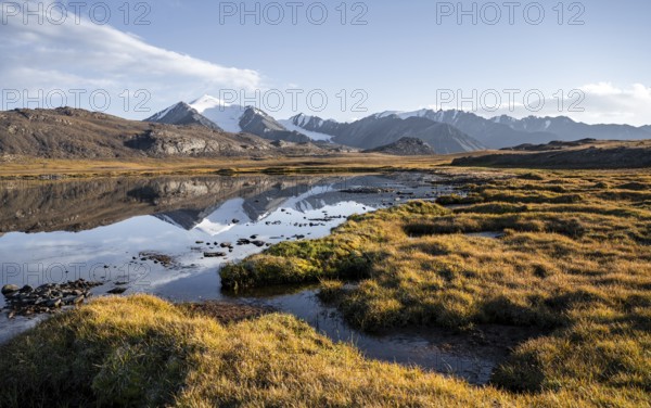 Glaciated mountain peaks reflected in a mountain lake at sunset, Arabel Lake at Arabel Pass, Issyk