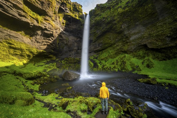 Tourist at Kvernufoss waterfall, in summer when the weather is nice, gorge and river, long