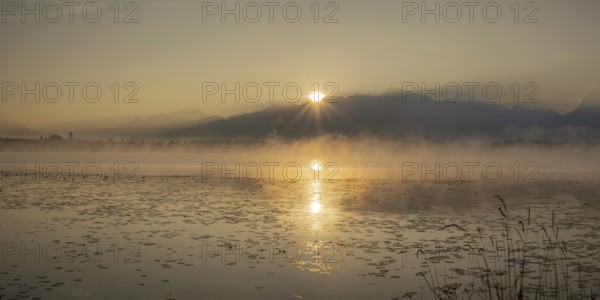 Sunrise at Lake Hopfensee near Füssen, behind Hopfen am See, the Tegelberg massif and the Säuling,
