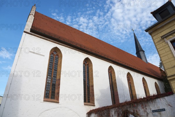 Church with red tiled roof and Gothic windows under a blue sky, St Augustin's Monastery Church,