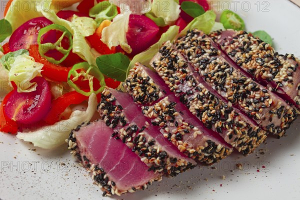 Fillet of red tuna meat, fried in sesame seeds, homemade, close-up, no people, on a wooden