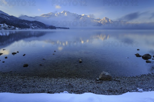 Mountains reflected in lake, morning light, fog, winter, snow, Lake Kochel, Alpine foothills,
