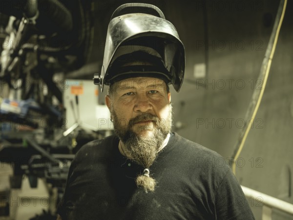 Welder in a tunnel section of the double shield tunnel boring machine in the H53 construction lot