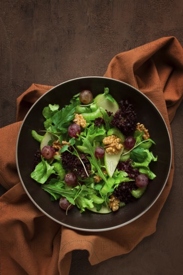 Fresh salad, waldorf, celery stalk, with apple and walnut, grapes, herbs, homemade, no people