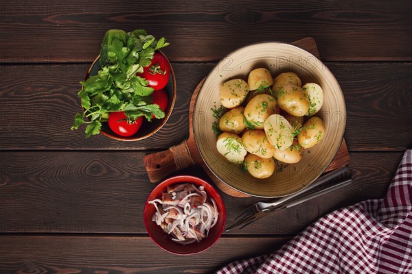Fresh Cooked, new potatoes, with dill, on a wooden table, selective focus. close-up, toning, no
