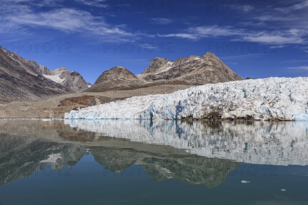 Glaciers and mountains reflected in fjord, sunny, East Greenland, Greenland, North America