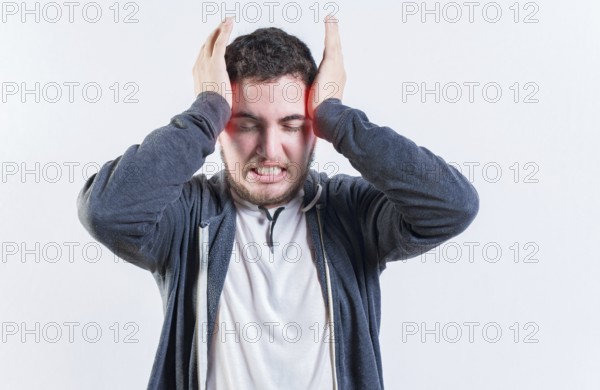 Suffering man with migraine massaging head isolated. Headache and migraine concept
