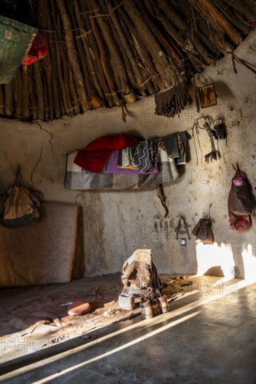Interior of a first woman's mud hut in a Himba village, traditional containers for ochre paint and
