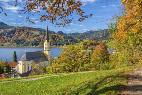 Panorama of the village and lake with the parish church of St. Sixtus in autumn, Schliersee,