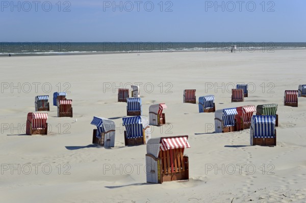 Colourful beach chairs on the beach, sand drifts, blue sky, North Sea, Juist, East Frisian Islands,