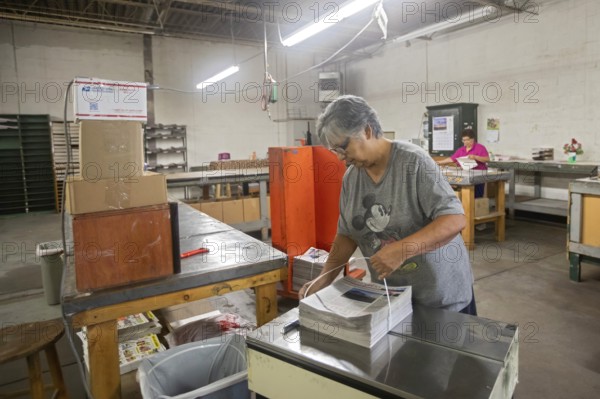 Liberal, Kansas, Lisa Diaz bundles copies of the Kiowa County (Colorado) Independent. The