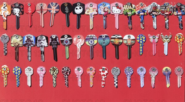 Display rows of picture Yale keys on red background, UK