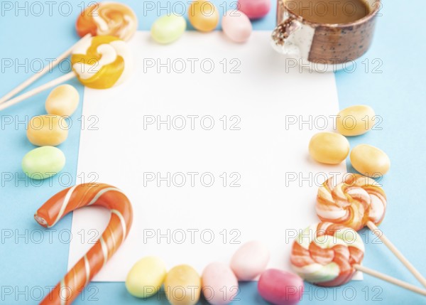 Composition with candies frame on blue pastel background. copy space, side view, template