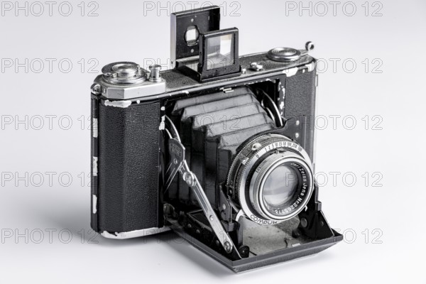 Old bellows camera with extended bellows and opened optical viewfinder