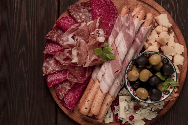 Appetizer, assortment, set, sausage, and cheese, on a wooden board, top view, no people